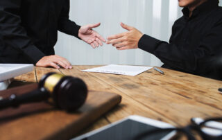 Client meeting with a local Lackawanna County attorney reviewing legal documents at a desk with a courtroom gavel.