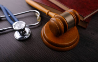 Judge’s gavel and medical stethoscope on a desk, symbolizing legal strategies to overcome the limited tort restriction and recover pain and suffering damages in Scranton.