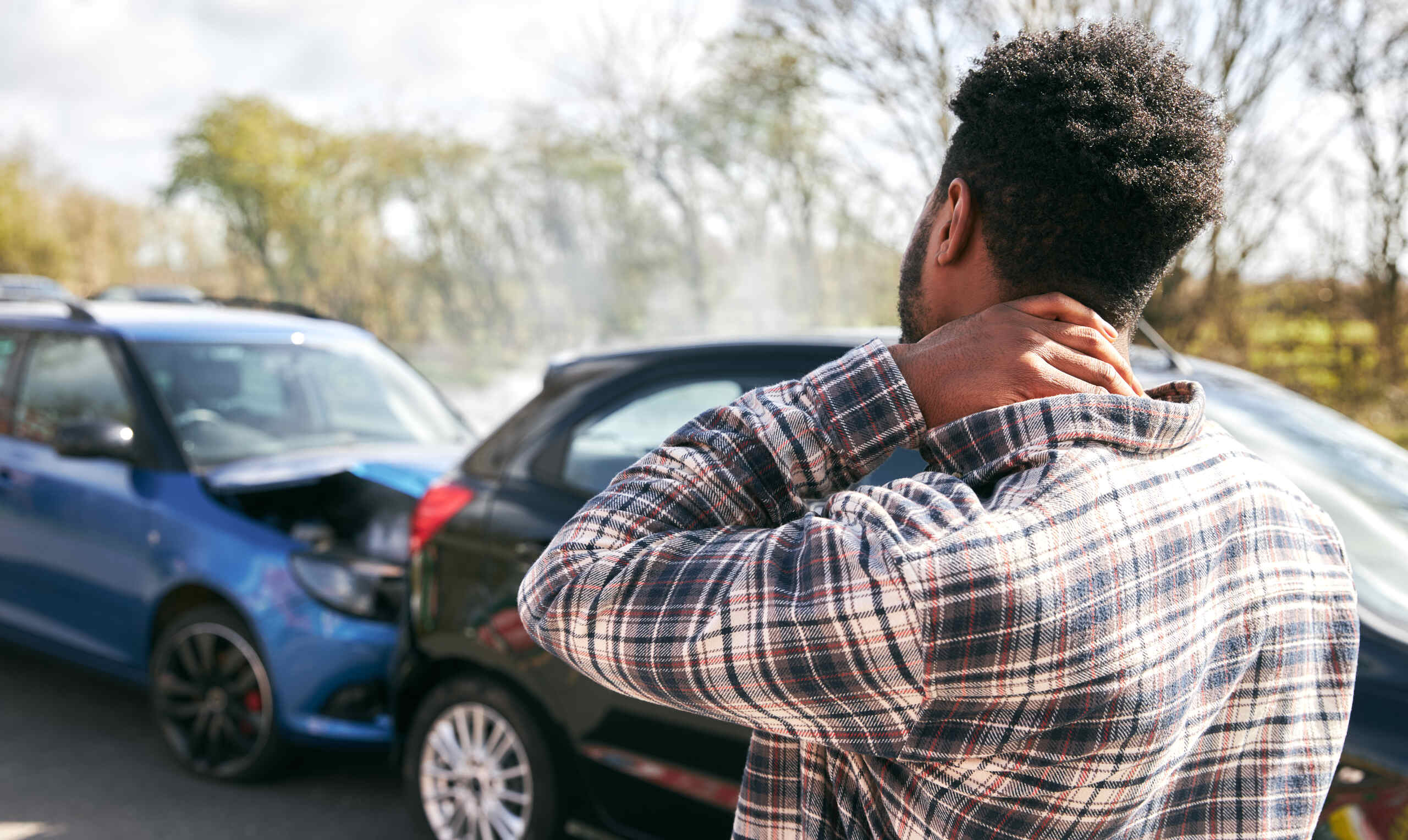 Injured driver holding his neck after a car accident, representing serious injury claims needed to bypass Pennsylvania’s limited tort rule in Scranton cases.