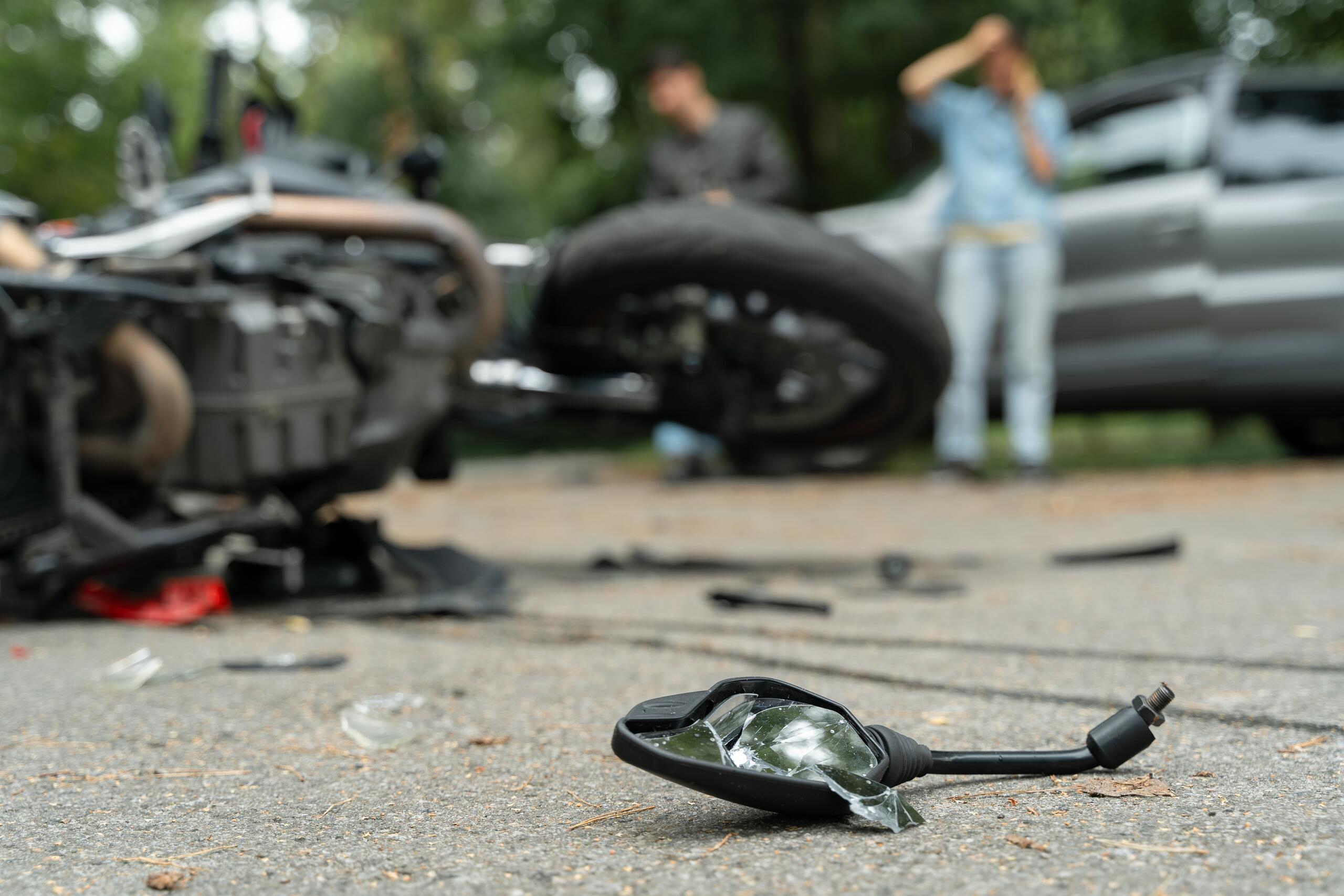 Motorcycle crash scene with debris on the road, representing partial liability and compensation claims in a Scranton accident case.