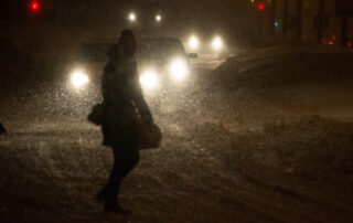 A pedestrian navigating dangerous low-visibility conditions where a hit and run pedestrian lawyer in Scranton can help if a driver flees the scene after a collision.