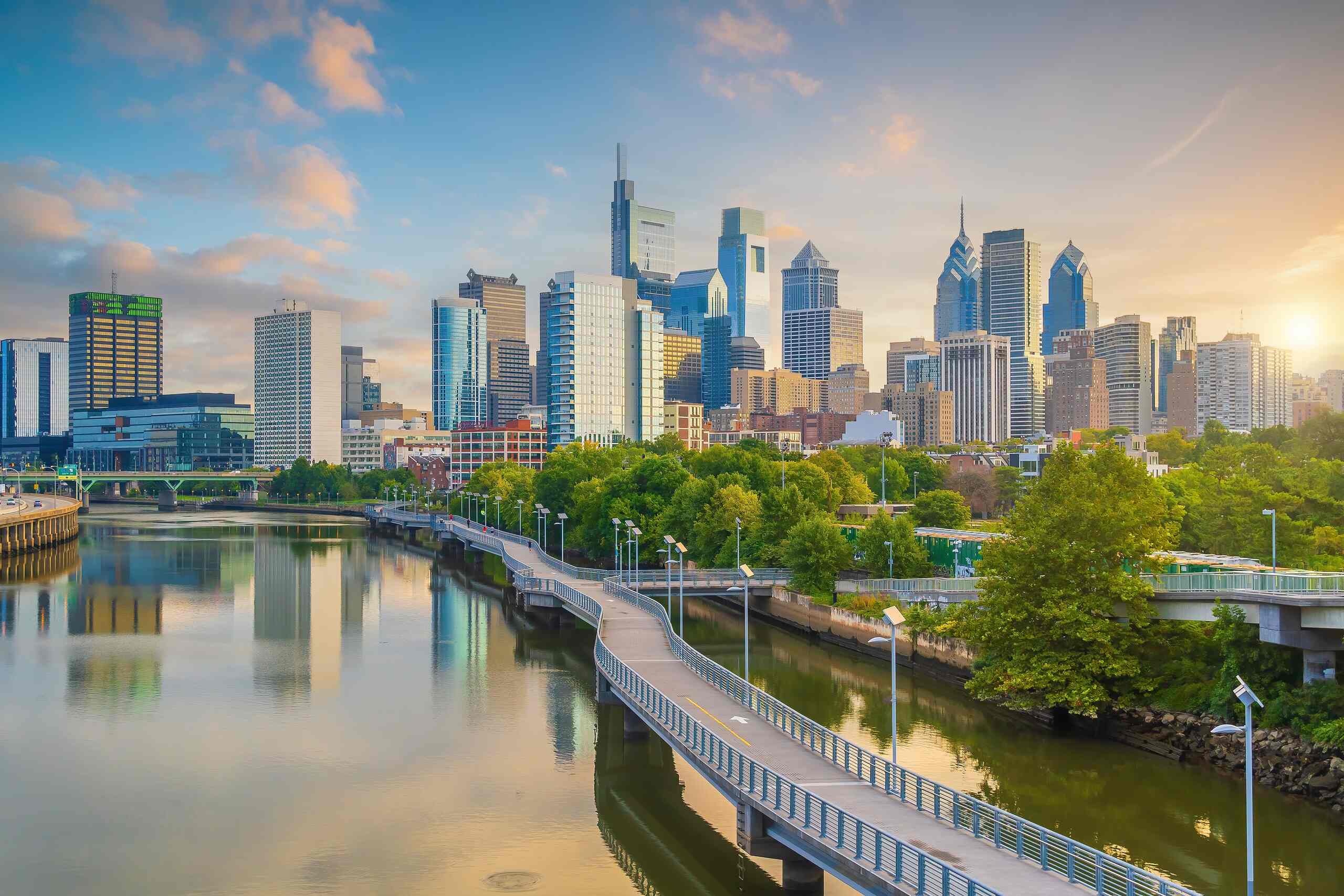 The Philadelphia skyline and riverfront at sunset, representing the service area where The Slocum Firm provides helpful legal support for personal injury claims.
