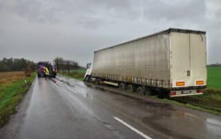 A large white tractor-trailer jackknifed on a wet road, illustrating the complex liability cases Scranton families face when piercing the independent contractor defense.
