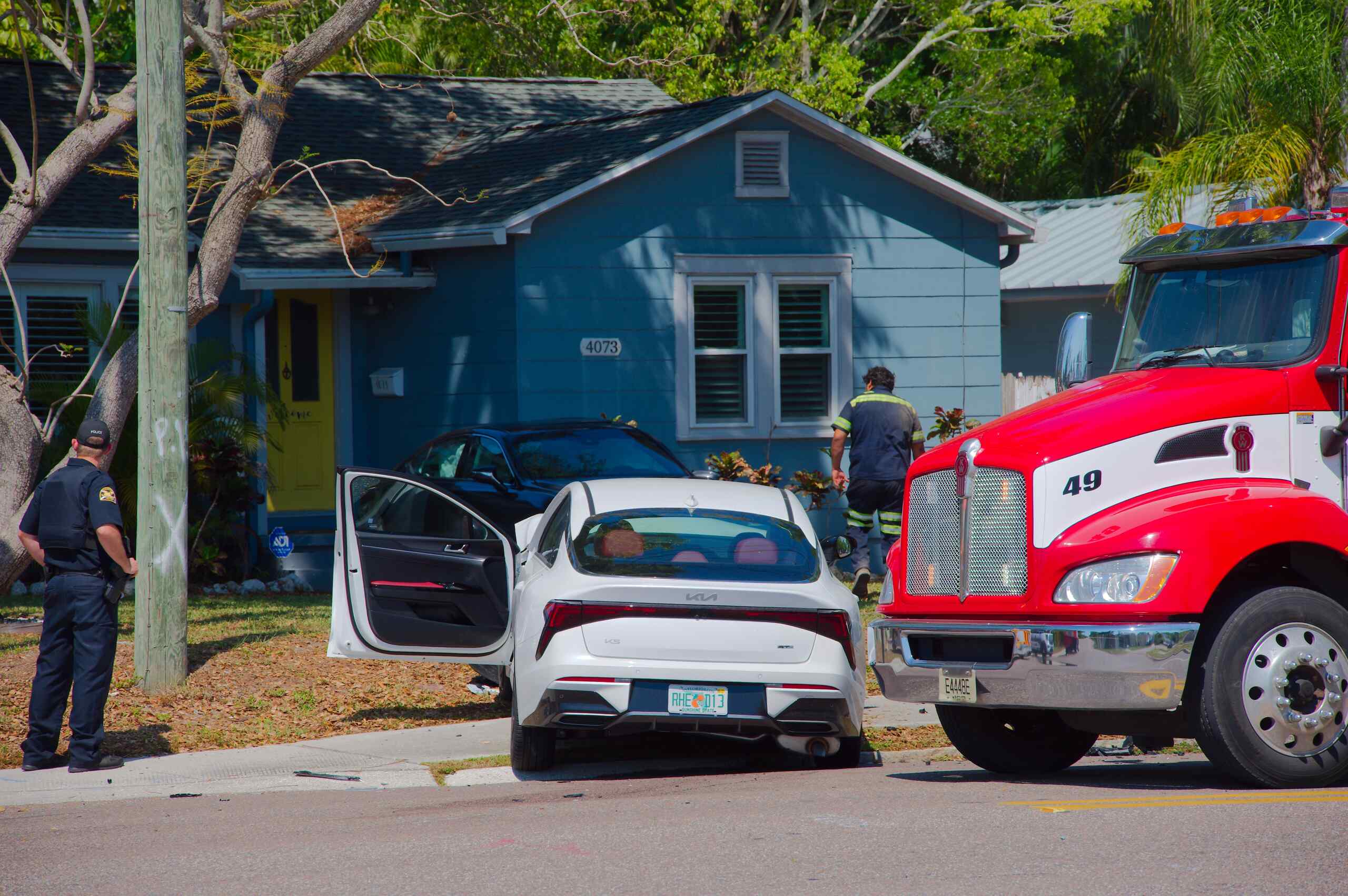 A red commercial truck involved in a collision with a white car at a residential intersection, representing trucking company liability in Scranton personal injury claims.