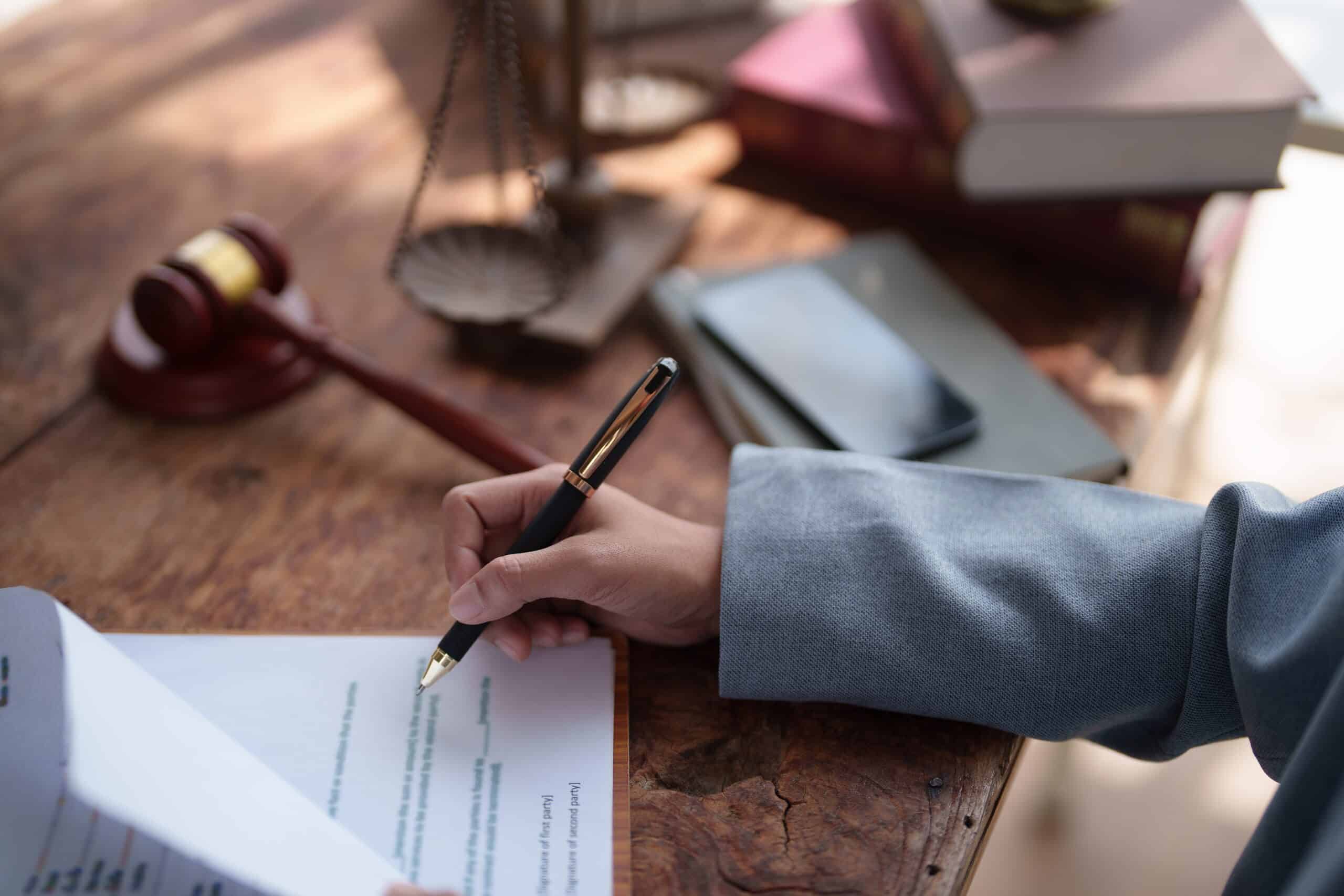A close-up of a person signing legal estate documents in Scranton, representing the personal representative's role in filing a Pennsylvania wrongful death lawsuit.