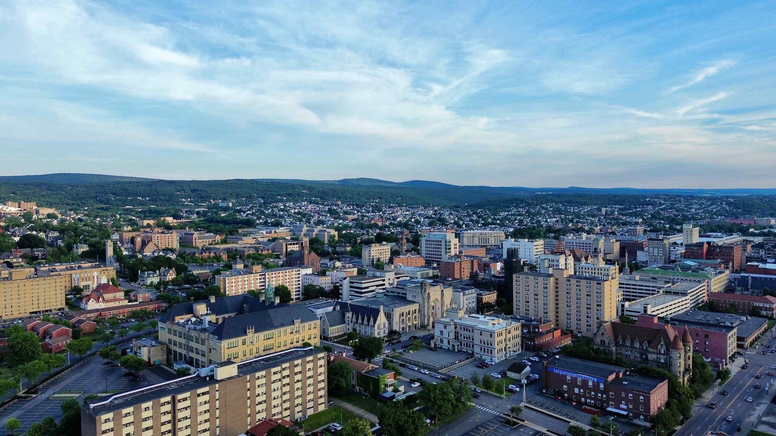 Wide aerial view of the Scranton, Pennsylvania cityscape under a blue sky, representing the geographic region served by Scranton Brain Injury Lawyers.