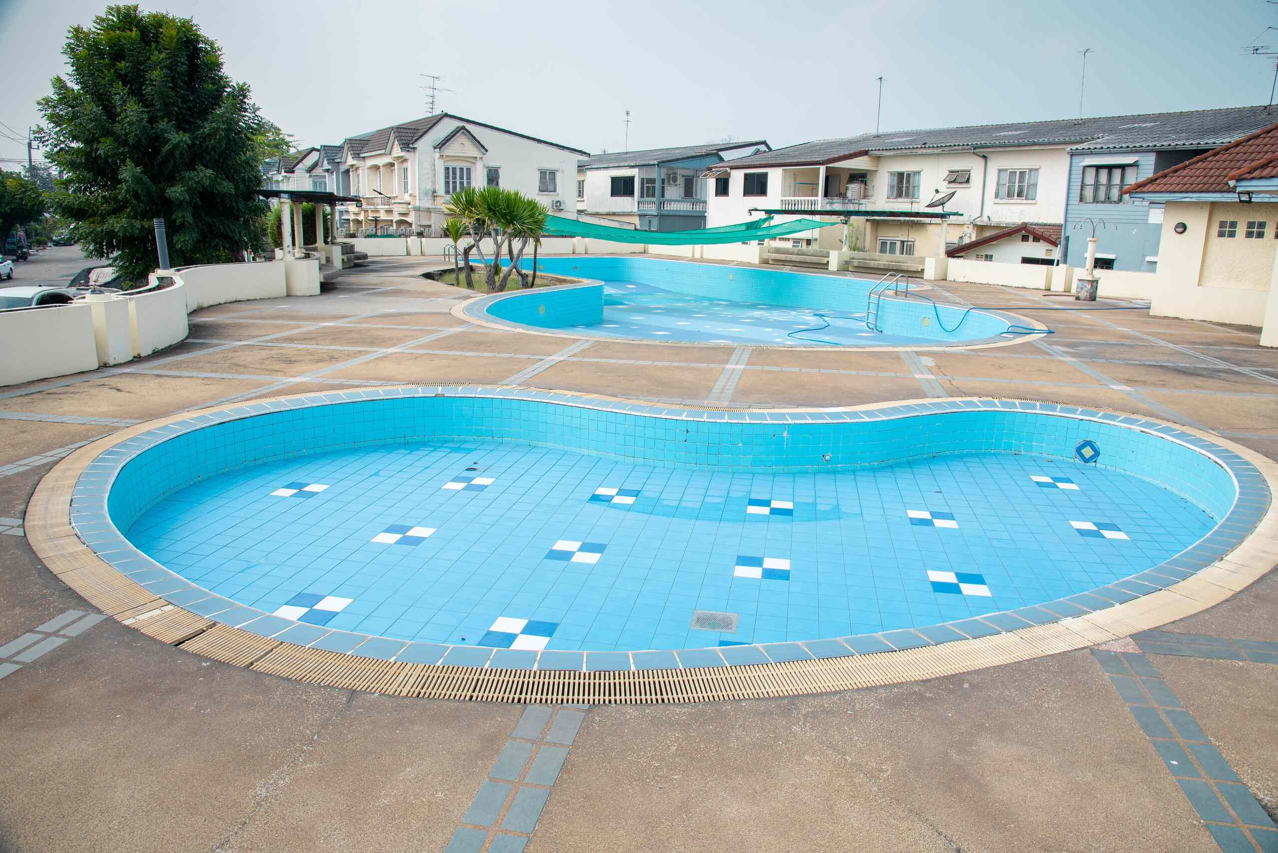 An outdoor residential community swimming pool area surrounded by concrete decking, representing premises liability cases handled by Scranton Swimming Pool Accident Lawyers.