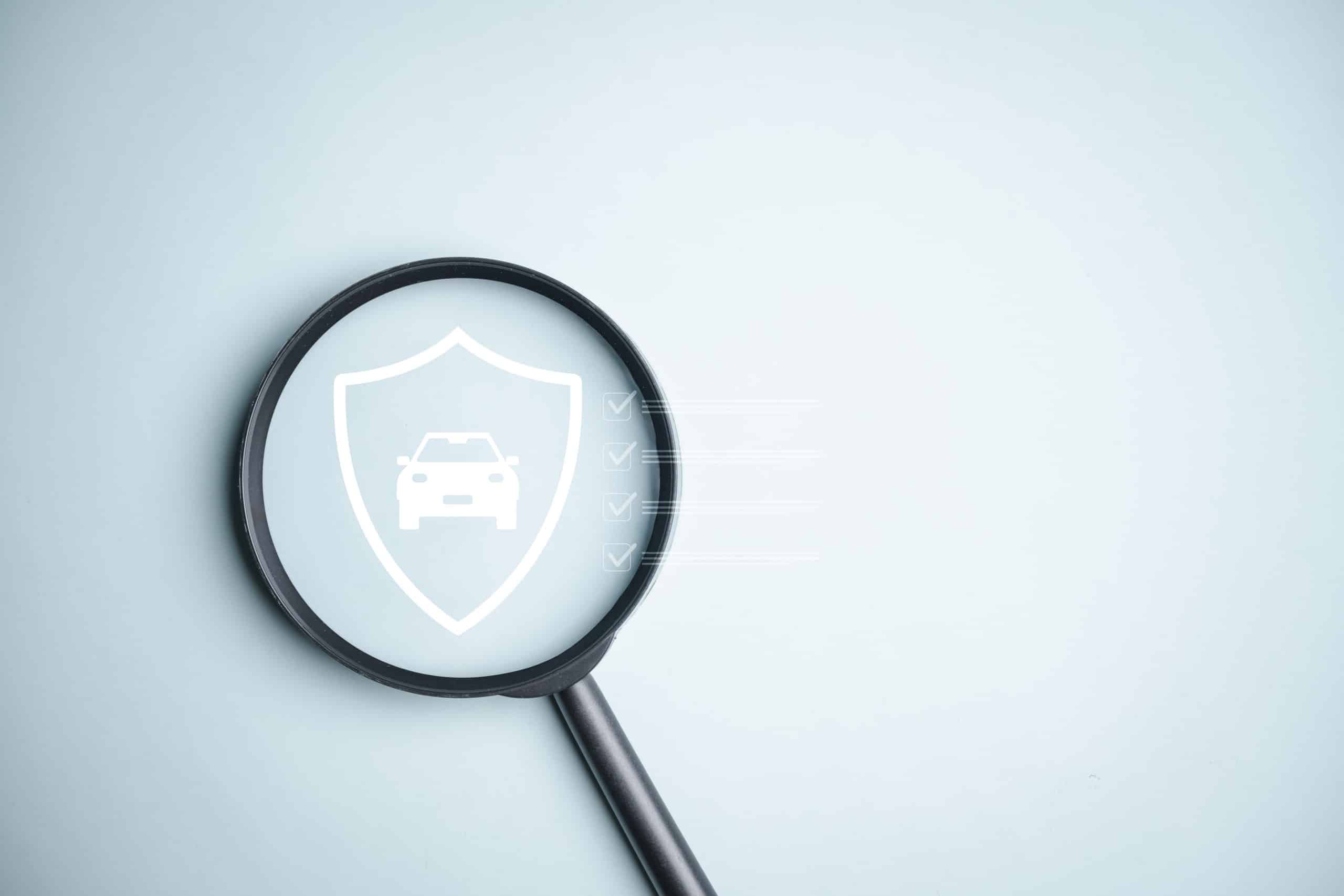 Magnifying glass over car insurance shield icon - Pennsylvania Hit and Run Accident Lawyers