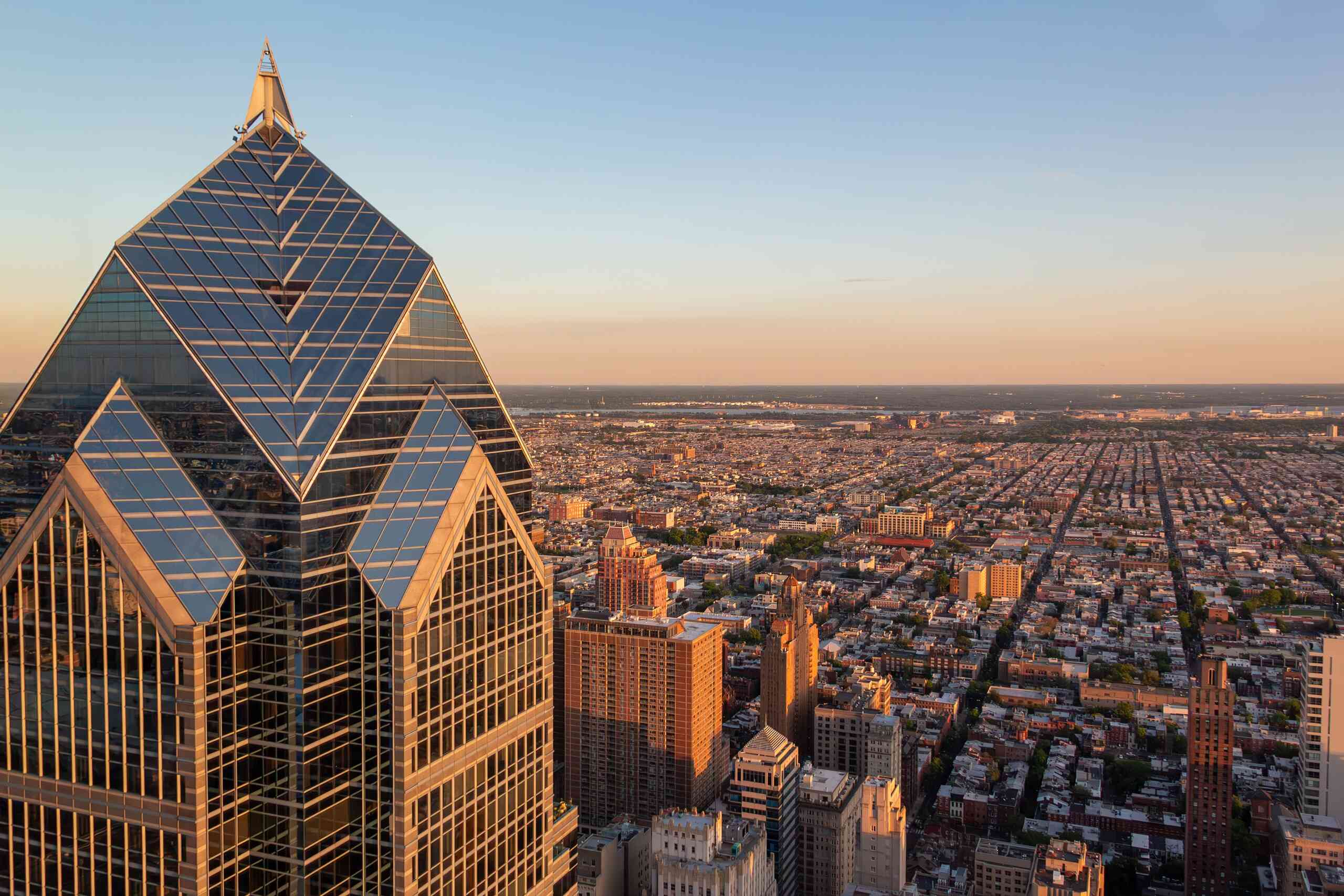 An aerial view of the Philadelphia skyline at sunset shows the region served by Pennsylvania Uninsured Motorist Lawyers.