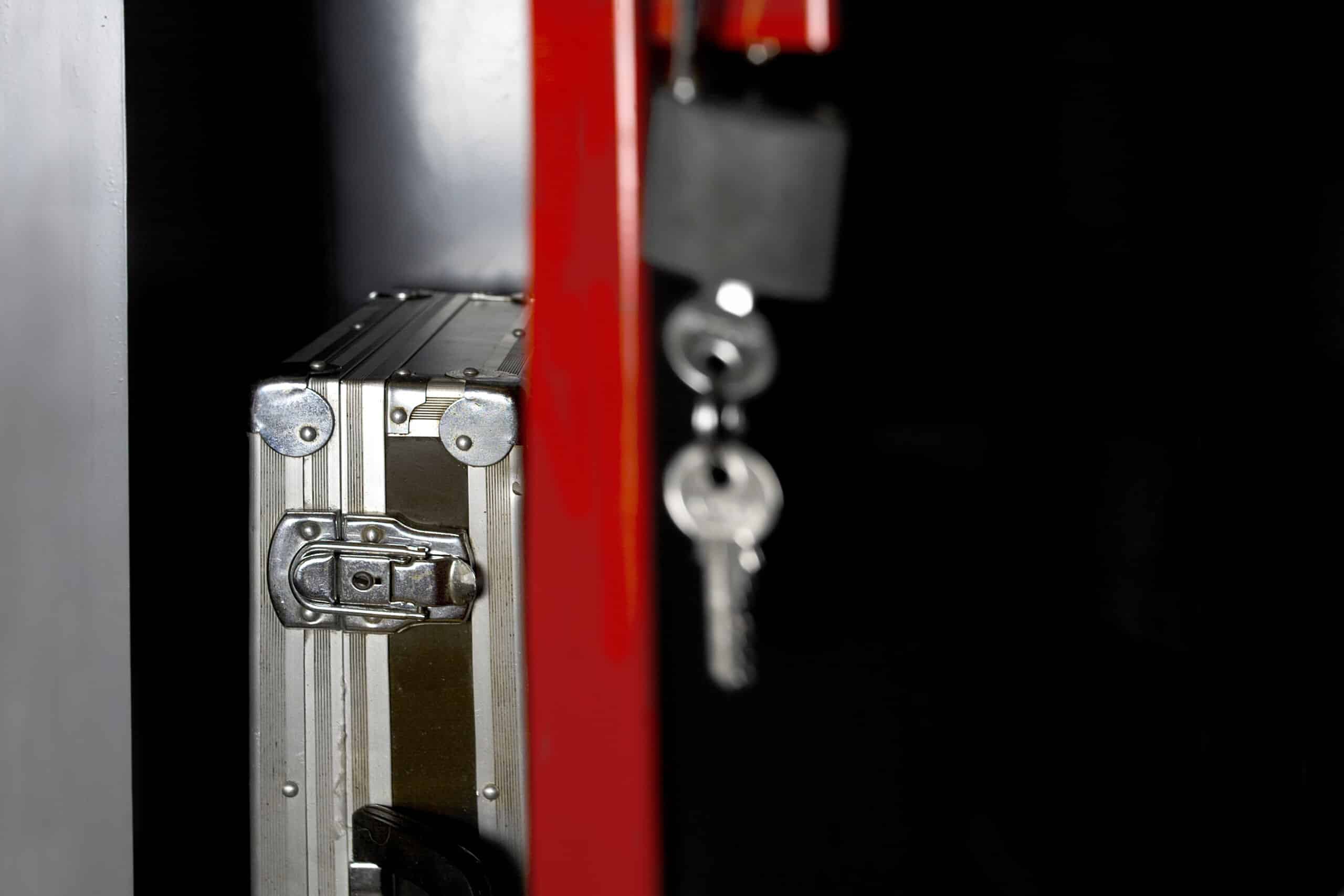 A metal briefcase sits near hanging keys highlighting property protection handled by Philadelphia Negligent Security Lawyers at The Slocum Firm.
