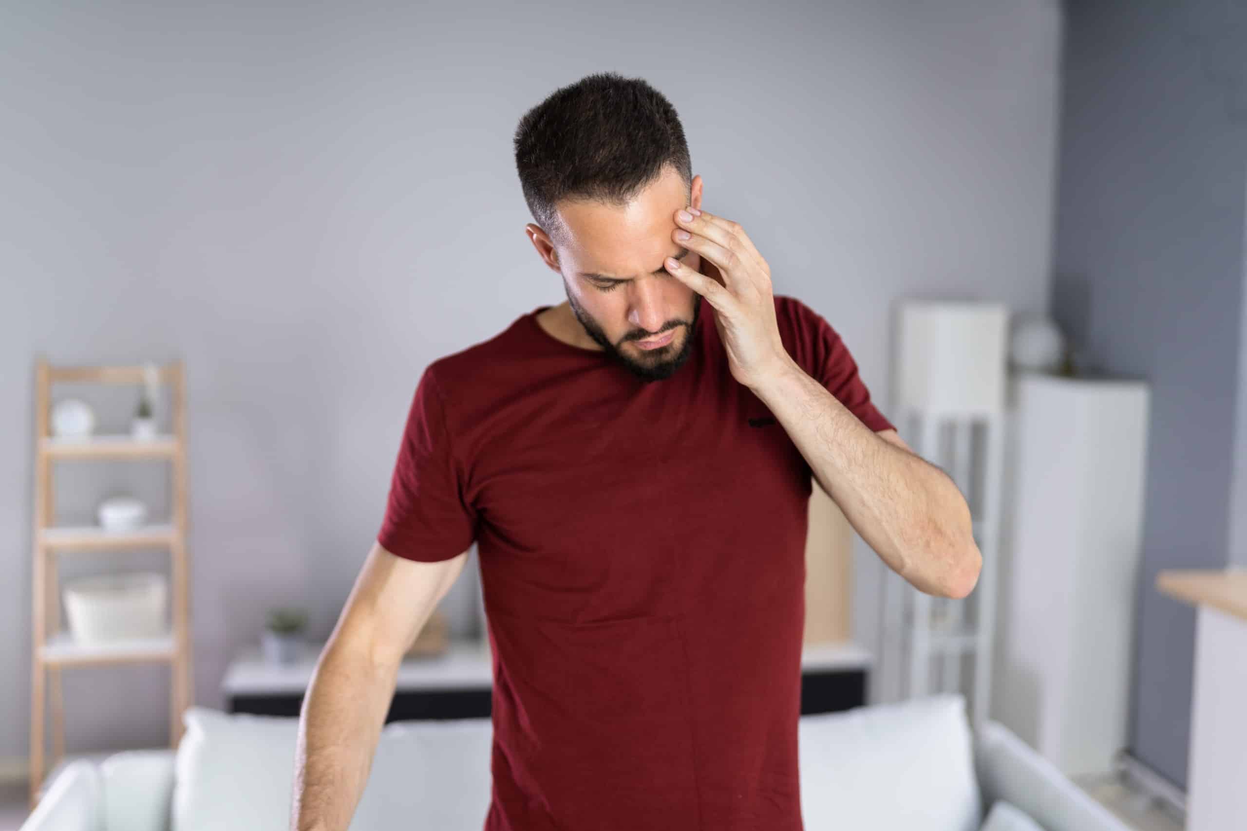 Man holding his head in pain due to severe head trauma represented by Pennsylvania traumatic brain injury lawyers.